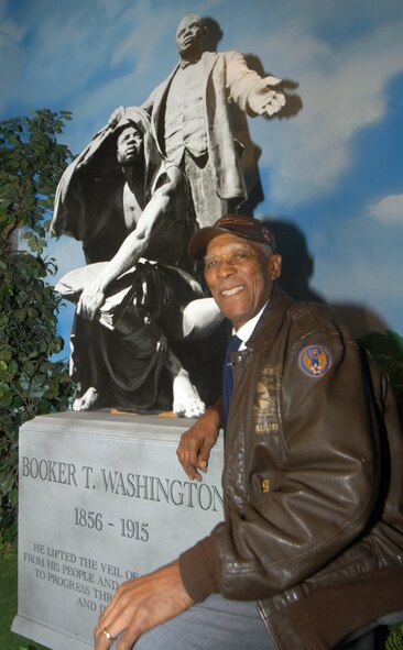 George Watson, Sr., a retired US Air Force technical sergeant, poses by a tribute to Booker T. Washington during a tour of the Tuskegee Airmen exhibit at the Musuem of Aviation Feb. 8. U. S. Air Force photo by Sue Sapp  