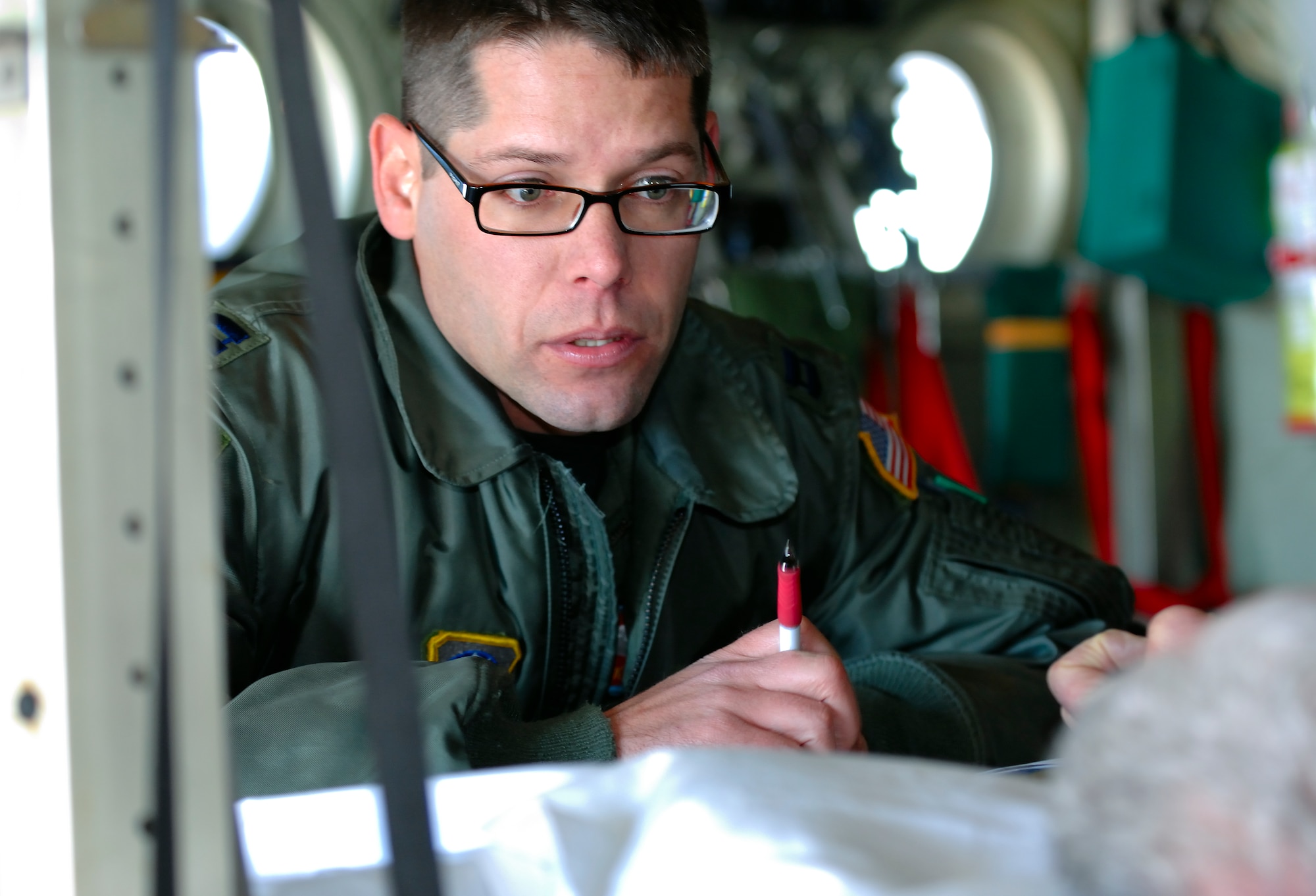 SCOTT AIR FORCE BASE, Ill. -- Capt. Kirk Smith, 375th Aeromedical Evacuation Squadron flight nurse, records medication provided to patient Feb. 9 at Scott AFB, Ill. The 375th Airlift Wing located at Scott is one of three Aeromedical Staging Facility distribution hubs in the continental United States that is responsible for transporting patients to their home bases or other specialized hospitals. (U.S. Air Force photo/Master Sgt. Maurice Hessel)