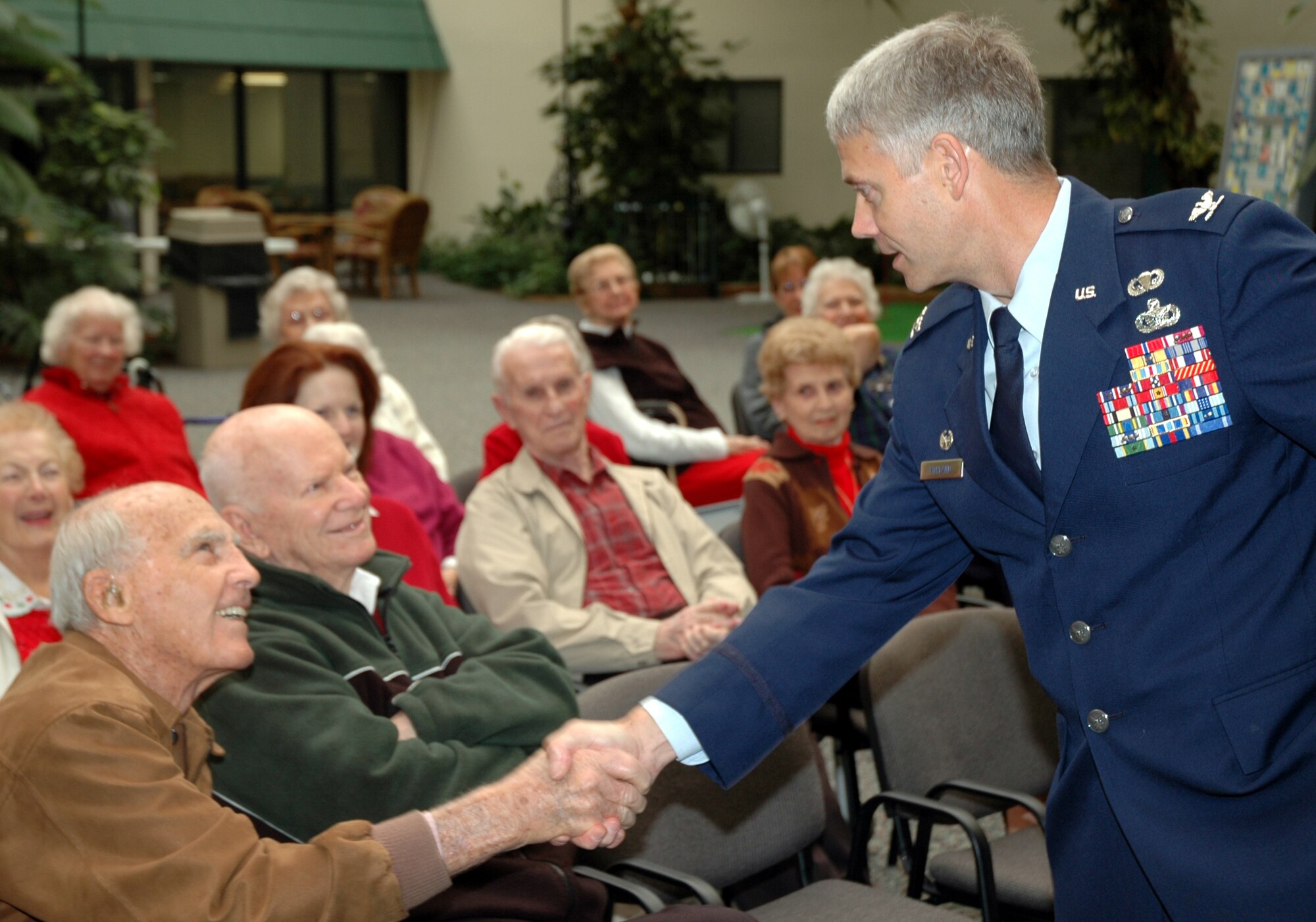 Col. Eric Pohland, 96th Air Base Wing commander, greets Col. (Ret.) Joseph Stanley during a Valentines for Vets visit to the Westwood Retirement Resort Feb. 14. Colonel Stanley was Eglin's commander in 1954 and recently clebrated his 100th birthday. More than 50 Eglin Airmen visited local veterans at four retirement facilities on Valentines Day. (Photo by Tech. Sgt. Brian Jones)