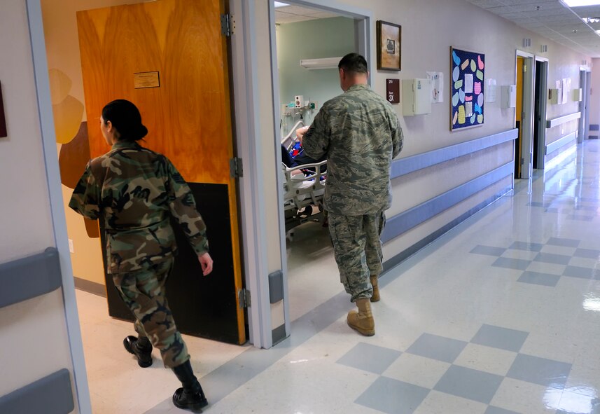 SCOTT AIR FORCE BASE, Ill. -- Staff Sgt. Valerie Silvia and Master Sgt. Ronald Threadgill, 375th Aeromedical Staging Facility aerospace medical technicians, check on their patients to ensure they have everything they need Feb. 9 at Scott AFB, Ill.  Scott is one of three ASF distribution hubs in the continental United States that is responsible for transporting patients to their home bases or other specialized hospitals. (U.S. Air Force photo/Master Sgt. Maurice Hessel)