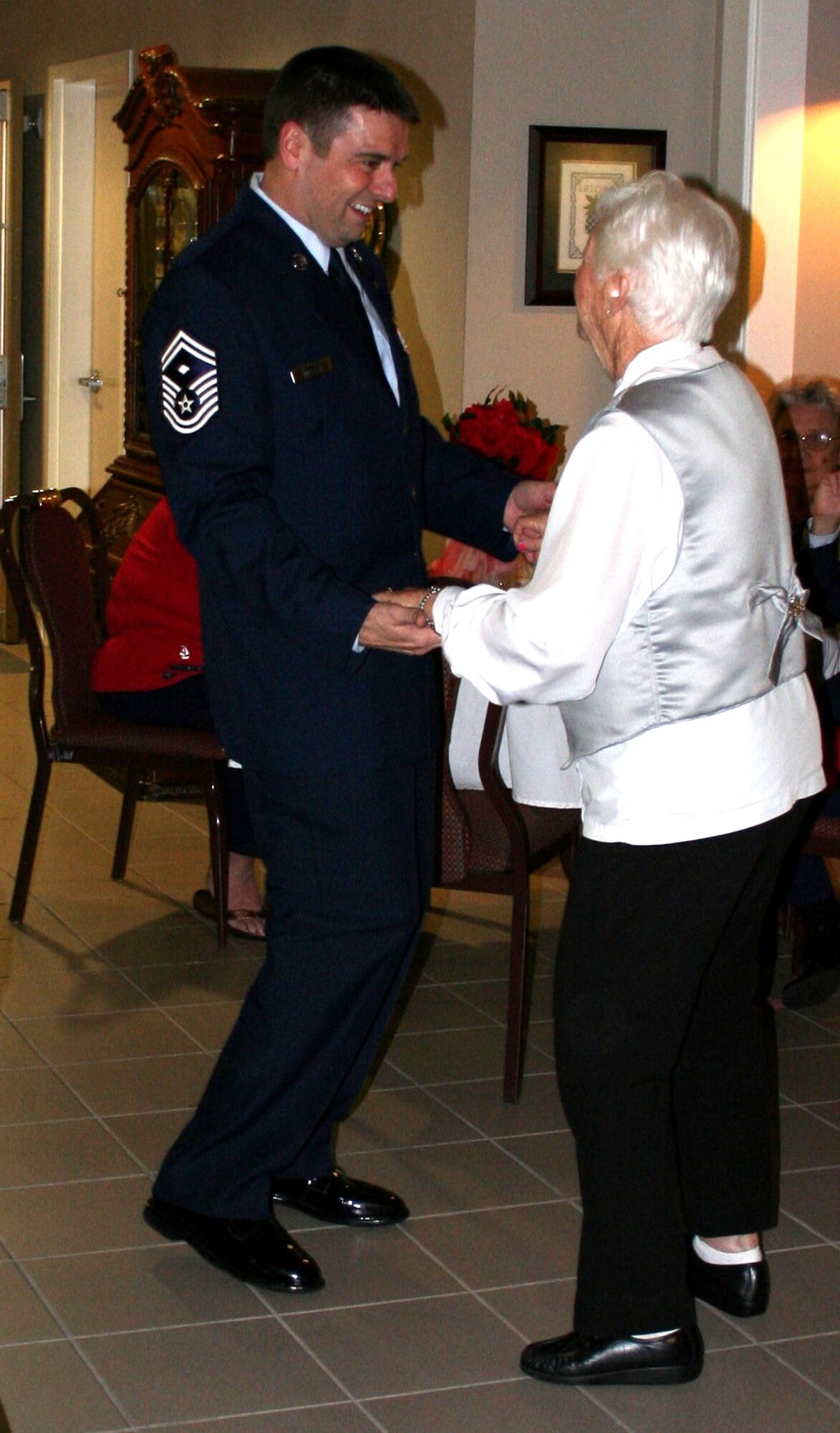 Senior Master Sgt. Scott Delveau dances with Harriet Curry during a special Valentine's Day Ball at the Air Force Enlisted Village's Hawthorn House in Shalimar, Fla.. More than thirty Airmen from nearby Hurlburt Field and Eglin Air Force Base joined residents Feb. 9 for the ball.  Hawthorn House is the AFEV's assisted living residence.  (U.S. Air Force photo/Jodi L. Jordan)