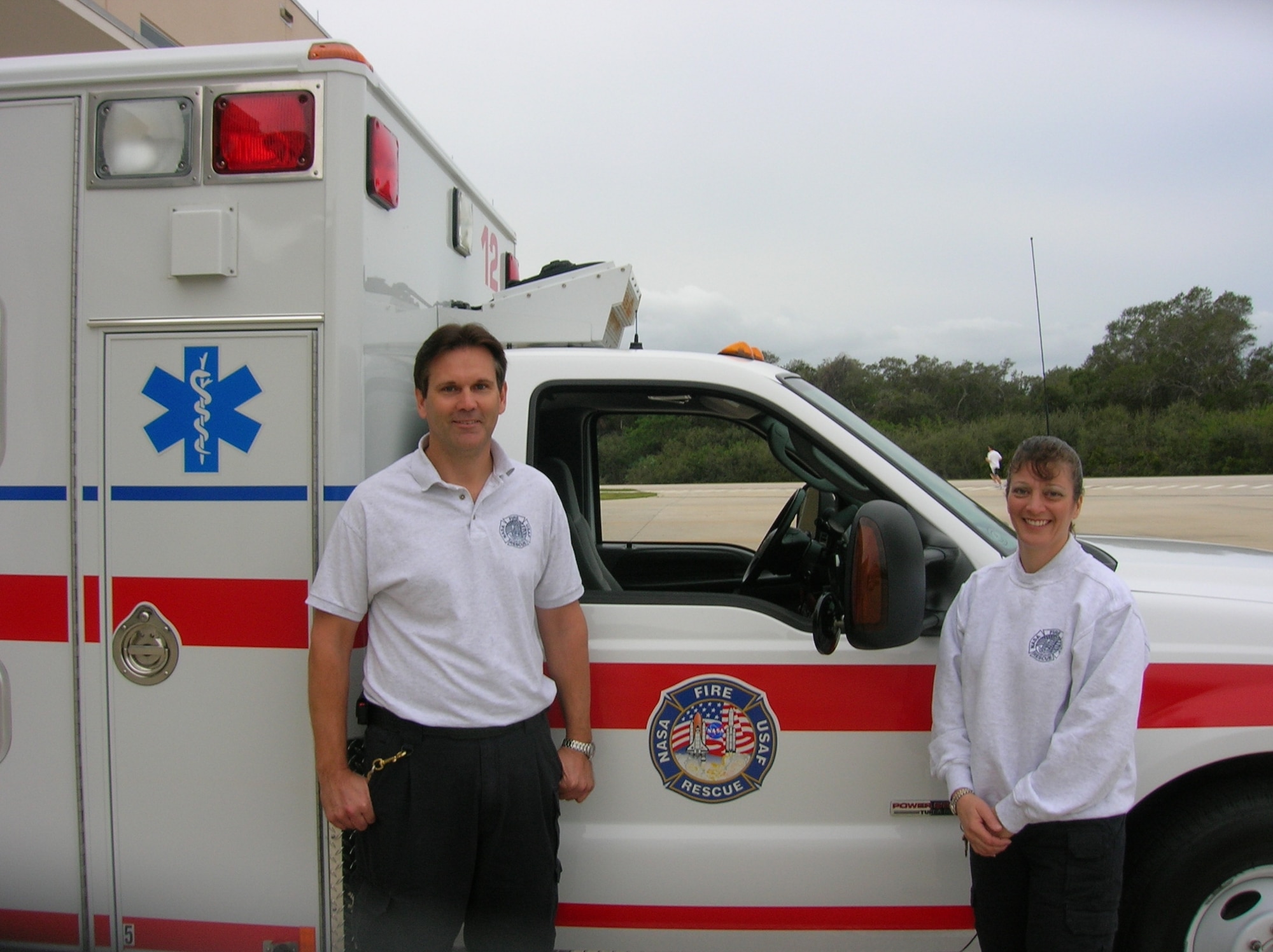 Dan Robiataille (left) and Michelle LaMoia of the Space Gateway Support Emergency Response Team with their ambulance at Cape Canaveral AFS. (Photo courtesy of Space Gateway Support)