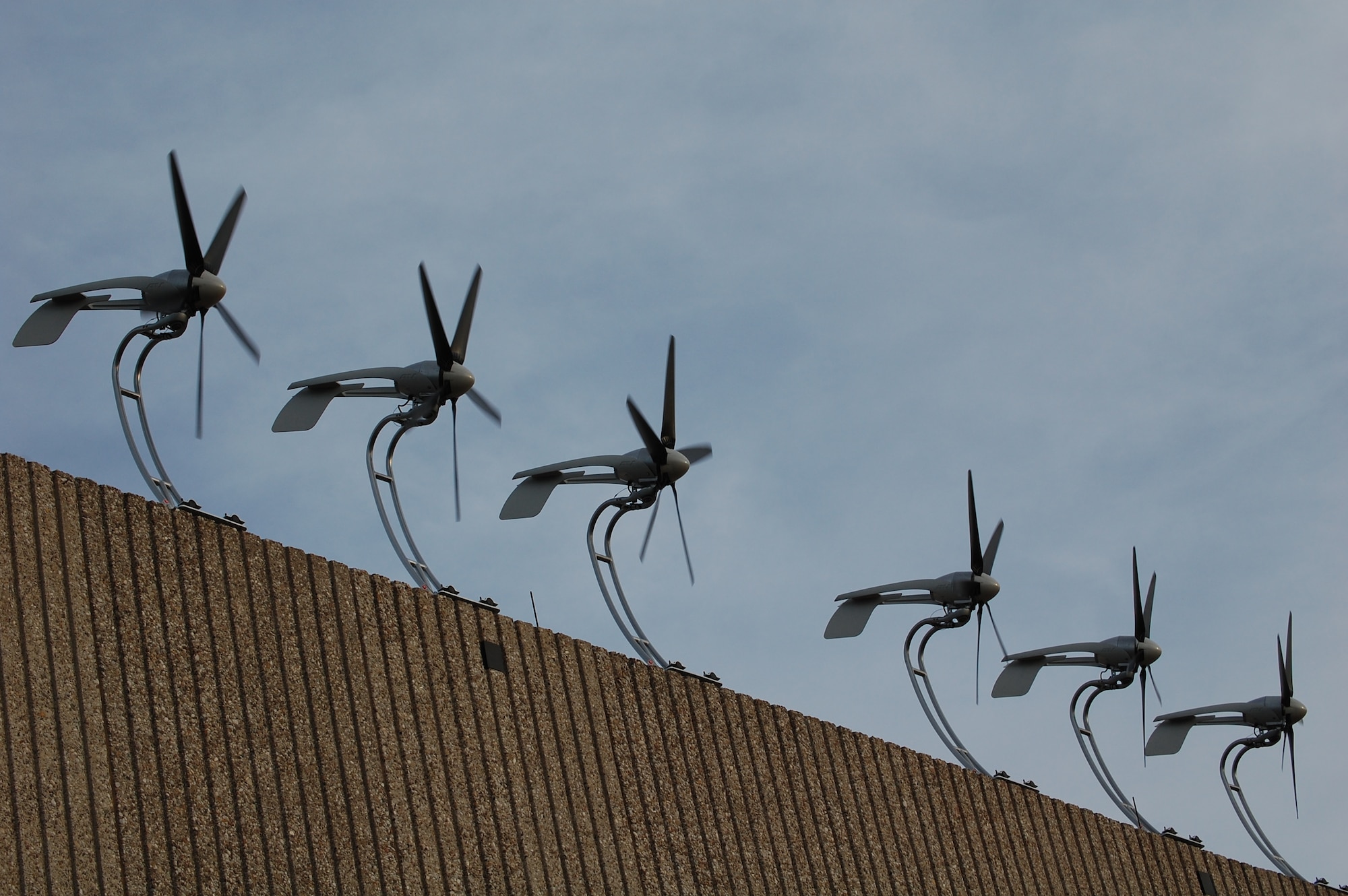 A picture shows the first Department of Defense’s architectural wind-energy system, consisting of six turbines, after its installation at Laughlin Air Force Base, Texas. The project, which started in the summer of 2006 and was completed mid-December of 2007, was driven by the Energy Policy Act and Executive Order 2007-01-24, which requires all bases to strive to have 7.5 percent of renewable energy sources by the year 2013. The initial demo project, which costs more that $39,000, is now completed, and according to officials here, it is the first of its kind in Air Education and Training Command, the Air Force and DoD. (U.S. Air Force photo/Senior Airman Olufemi Owolabi)