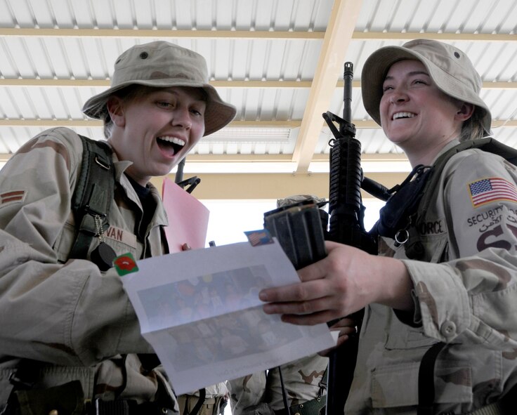Airmen 1st Class Kathleen Sullivan and Lindsay Judkins are surprised to receive Valentines from Texas elementary school students Feb. 13 at a Southwest Asia air base. Children from Merkel, Tye and Trent elementary schools sent more than 300 Valentines greetings thanking Airmen for their service and for keeping America free. Both Airmen are 379th Expeditionary Security Forces members and deployed from Schriever Air Force Base, Colo. (U.S. Air Force photo/Senior Airman Domonique Simmons 