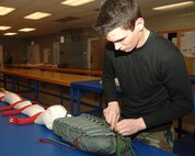 MINOT AIR FORCE BASE, N.D. -- Airman 1st Class Joshua Hooper, an aircrew flight equipment apprentice with the 5th Operations Support Squadron, stows the lines on a parachute here Feb. 12. The parachutes are inpected and repacked every 180 days. (U.S. Air Force photo by Airman 1st Class Sharida Bishop)