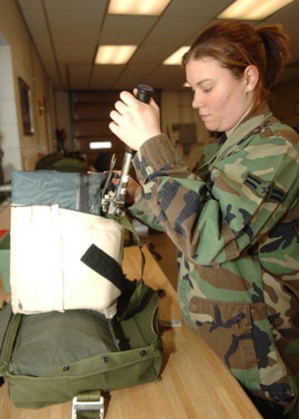 MINOT AIR FORCE BASE, N.D. -- Airman 1st Class Jaime Wood, an aircrew flight equipment apprentice with the 5th Operations Support Squadron, uses a precision torque wrench on a life raft during the repacking of the ML-4 survival kit here Feb. 12. The ML-4 survival kit contains essential items for pilots during flights. (U.S. Air Force photo by Airman 1st Class Sharida Bishop)
