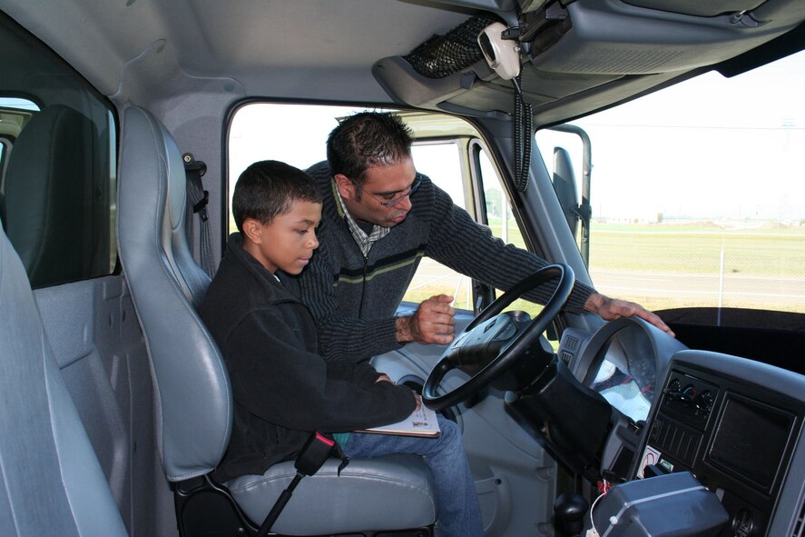 Rene Tudon, Moron Air Base Fuels manager, shows Kyle Mullinix the cab of an aircraft refueling truck. (photo by Staff Sgt. Joshua K. Mueller) 