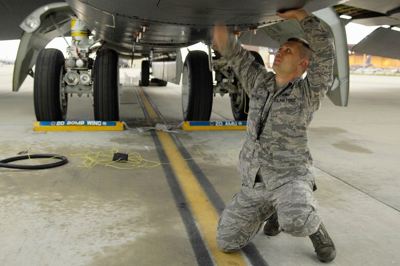 BARKSDALE AFB, LA - Staff Sergeant Benjamin Norton, 2d Aircraft Maintenance Unit, shuts the crew door on a a perfectly maintained B-52H. Sgt. Norton is the crew chief responsible for the planes perfect checklist, an event which only happens around once every ten years. (USAF Photo By SSgt Stephen J. Otero, RELEASED)