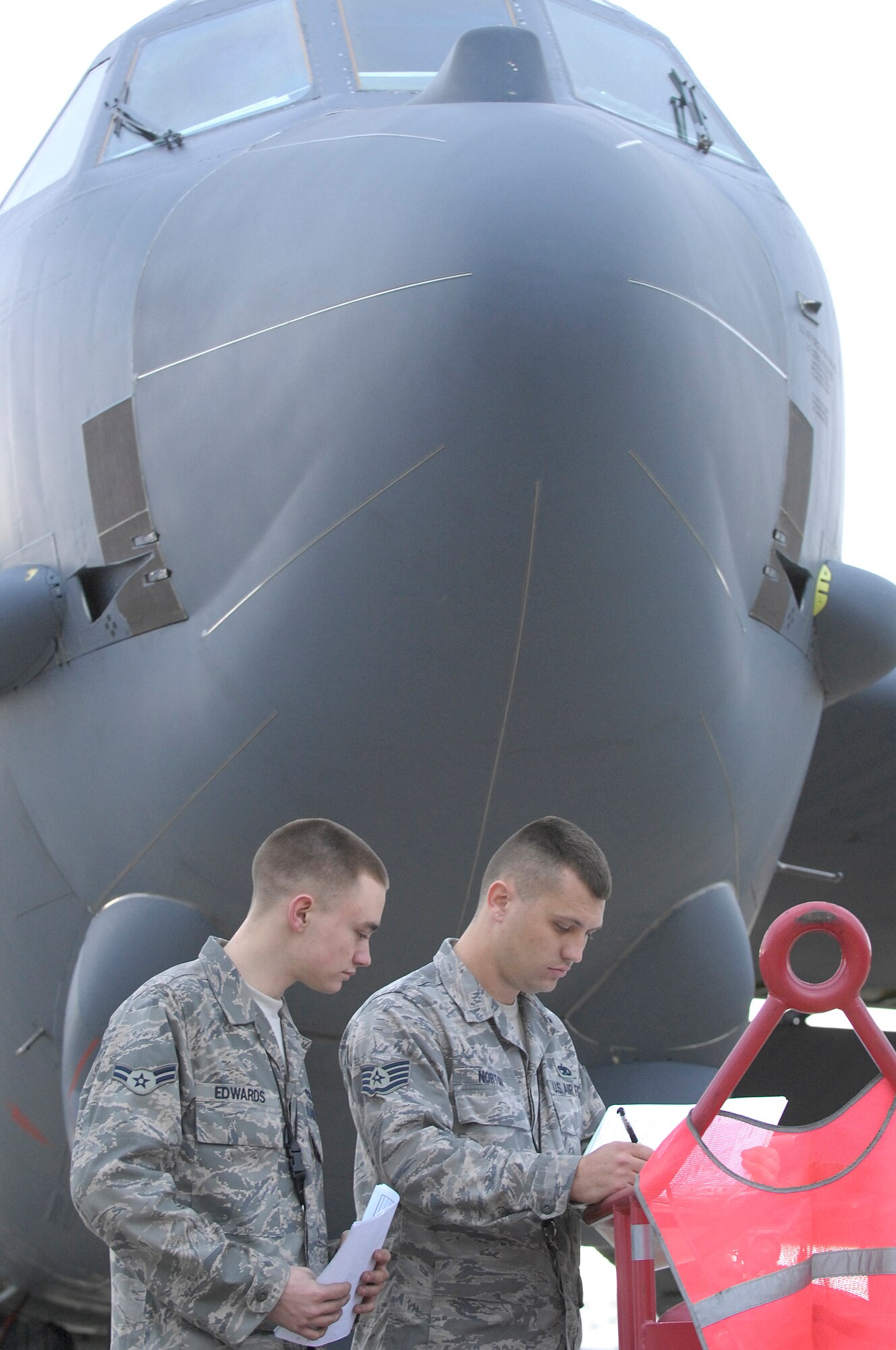 BARKSDALE AFB, LA - (From left) Amn First Class Jason Edwards and Staff Sergeant Benjamin Norton, crew chief's with the 2d Aircraft Maintenance Unit, review a B-52H pre-flight checklist signifying a perfectly maintained plane. Amn Edwards and Sgt. Norton are responsible for the planes perfect checklist, an event which only happens around once every ten years. (USAF Photo By SSgt Stephen J. Otero, RELEASED)
