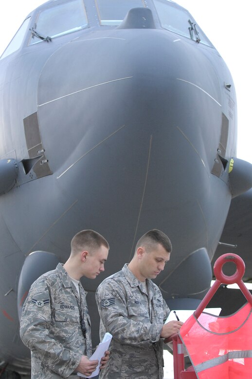 BARKSDALE AFB, LA - (From left) Amn First Class Jason Edwards and Staff Sergeant Benjamin Norton, crew chief's with the 2d Aircraft Maintenance Unit, review a B-52H pre-flight checklist signifying a perfectly maintained plane. Amn Edwards and Sgt. Norton are responsible for the planes perfect checklist, an event which only happens around once every ten years. (USAF Photo By SSgt Stephen J. Otero, RELEASED)