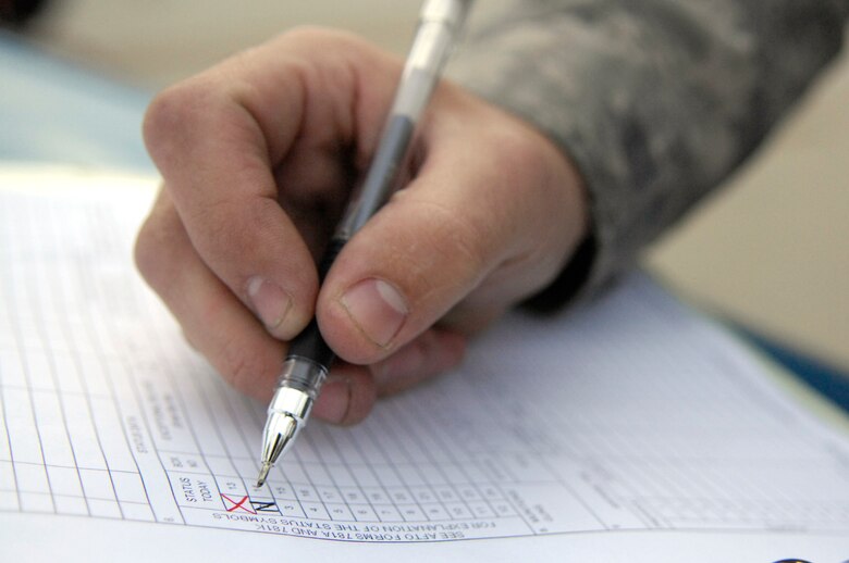 BARKSDALE AIR FORCE BASE, La. - Staff Sgt. Benjamin Norton, 2d Aircraft Maintenance Squadron, leaves his mark on a B-52H pre-flight checklist signifying a perfectly maintained plane. Sergeant Norton is the crew chief responsible for the plane's perfect checklist, an event which only happens around once every ten years. USAF Photo By Staff Sgt. Stephen J. Otero (RELEASED)