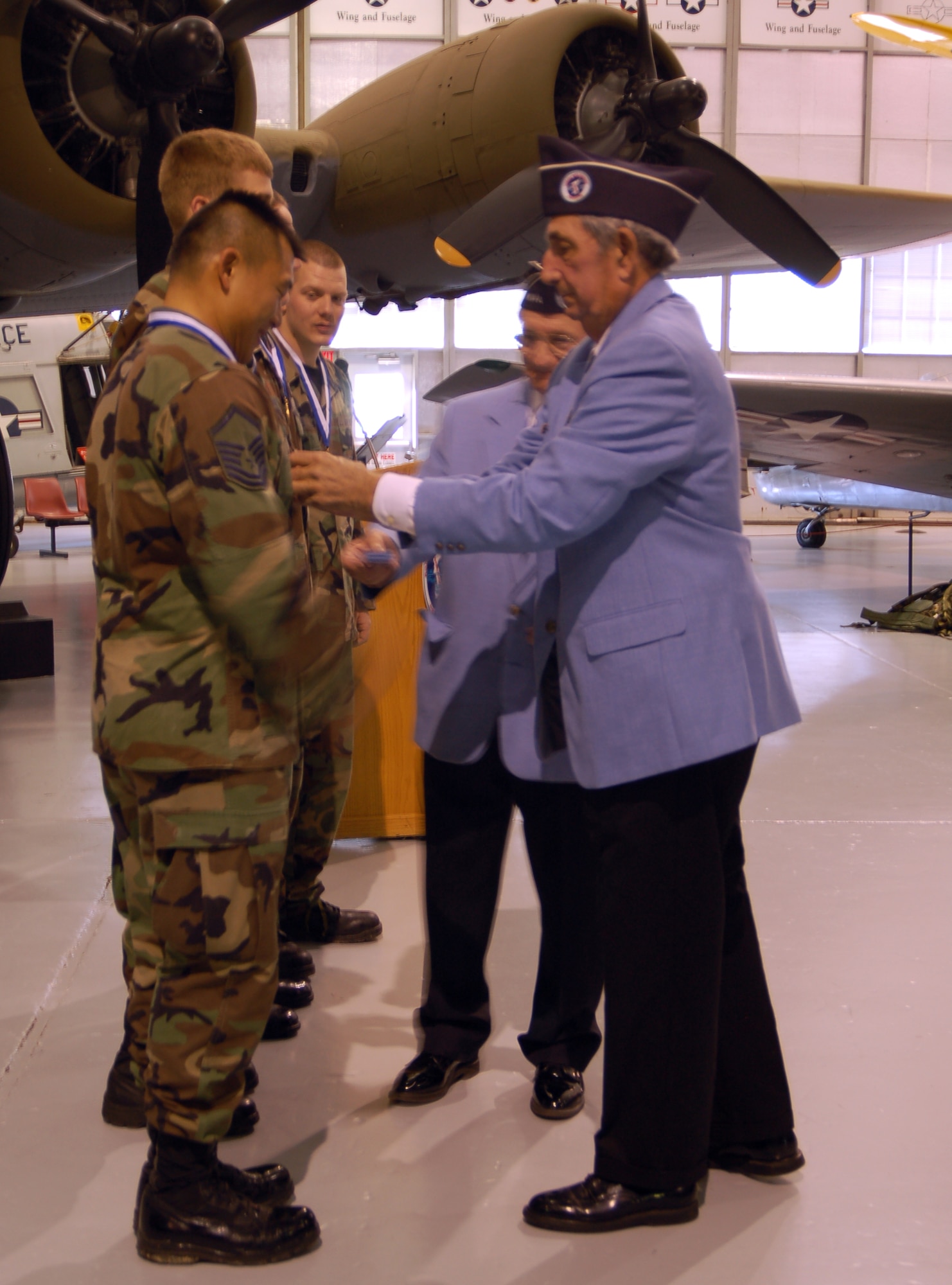 Master Sgt. Sam Louie, 436th Aerial Port Squadron and leader of the winning team, receives his medal from Korean War veterans Feb. 2. Sergeant Louie’s team of four all received medals for their 1st-place winning time of 1 hour and 59 seconds in a 6.2 mile march to commemorate veterans of the Korean War Battle of Chosin Reservoir. (U.S. Air Force photo/Airman 1st Class Shen-Chia Chu)