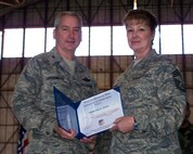 SEYMOUR JOHNSON AIR FORCE BASE, N.C. -- Chief Master Sgt. Joyce Fromm (right)  receives a Get One award from Col. Fritz Linsenmeyer, wing commander of the 916th Air Refueling Wing. The Get One award is presented by the Reserve wing's recruiting office to current members who have made a referral resulting in a new member joining the Air Force Reserve. U.S. Air Force photo/Tech. Sgt. Ian Gardner