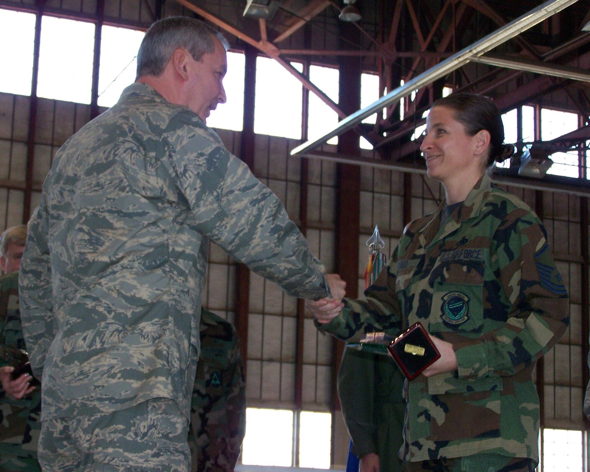 SEYMOUR JOHNSON AIR FORCE BASE, N.C. -- Master Sgt. Jennifer Ward (right) shakes hands with Col. Fritz Linsenmeyer, wing commander of the 916th Air Refueling Wing, after receiving her award for Senior Noncommissioned Officer of the Year for 2007. Sgt. Ward is a reservist with the 916th Aircraft Maintenance Squadron. U.S. Air Force photo/Tech. Sgt. Ian Gardner