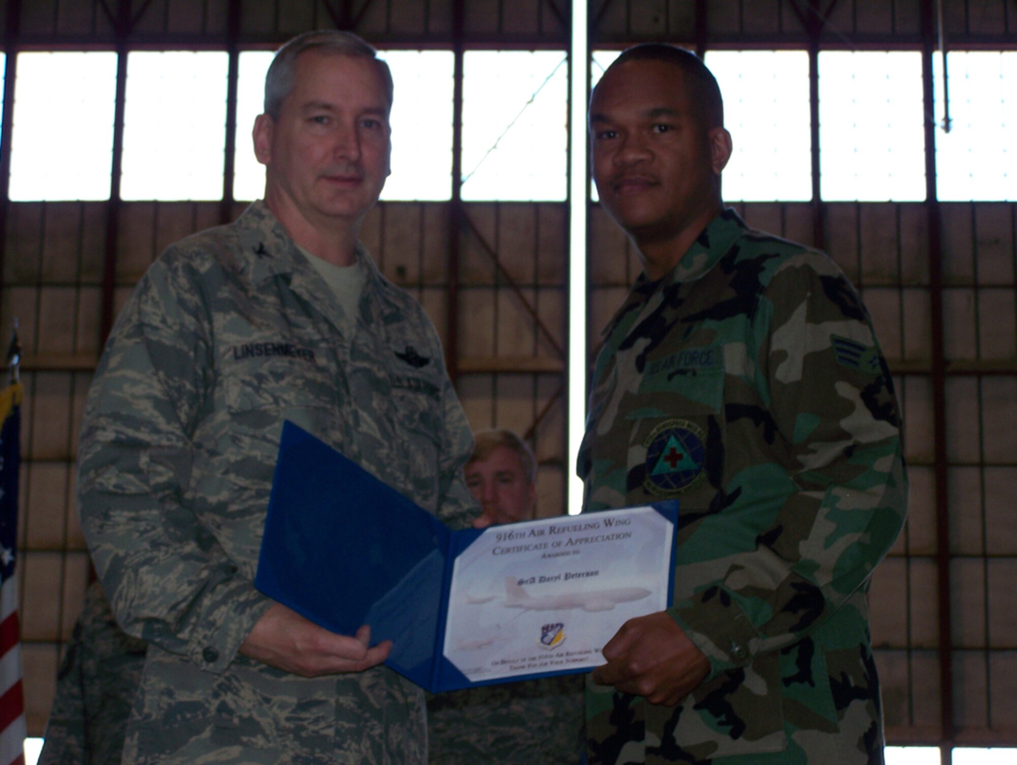 SEYMOUR JOHNSON AIR FORCE BASE, N.C. -- Senior Airman Daryl Peterson (right)  receives a Get One award from Col. Fritz Linsenmeyer, wing commander of the 916th Air Refueling Wing. The Get One award is presented by the Reserve wing's recruiting office to current members who have made a referral resulting in a new member joining the Air Force Reserve. U.S. Air Force photo/Tech. Sgt. Ian Gardner