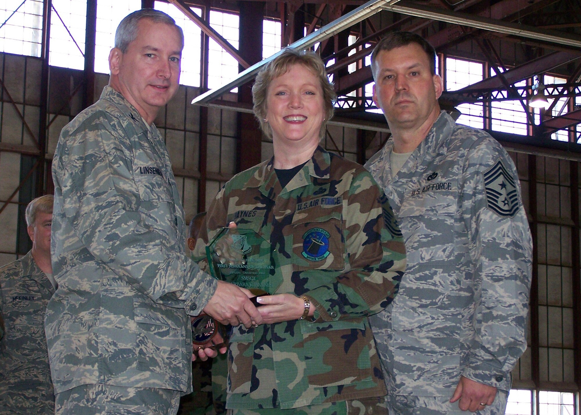 SEYMOUR JOHNSON AIR FORCE BASE, N.C. -- Senior Master Sgt. Barbara Haynes  (middle) earns the First Sergeant of the Year Award for 2007 for the 916th Air Refueling Wing. Col. Fritz Linsenmeyer (left), wing commander and Command Chief Master Sgt. Lester Boltinhouse present the award the maintenance operations flight first sergeant during the February unit training assembly. U.S. Air Force photo/Tech. Sgt. Ian Gardner