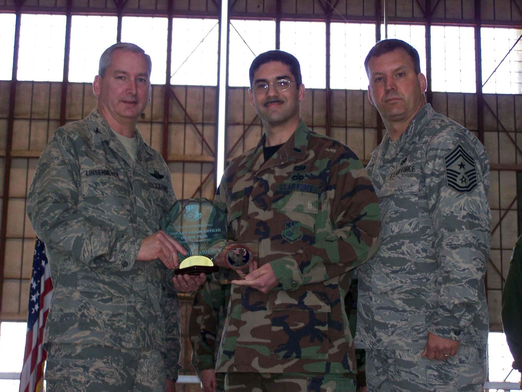SEYMOUR JOHNSON AIR FORCE BASE, N.C. -- 1Lt. David Ramirez (middle) earns the Company Grade Officer of the Year Award for 2007 for the 916th Air Refueling Wing. Col. Fritz Linsenmeyer (left), wing commander and Command Chief Master Sgt. Lester Boltinhouse present the award the intelligence officer during the February unit training assembly. U.S. Air Force photo/Tech. Sgt. Ian Gardner