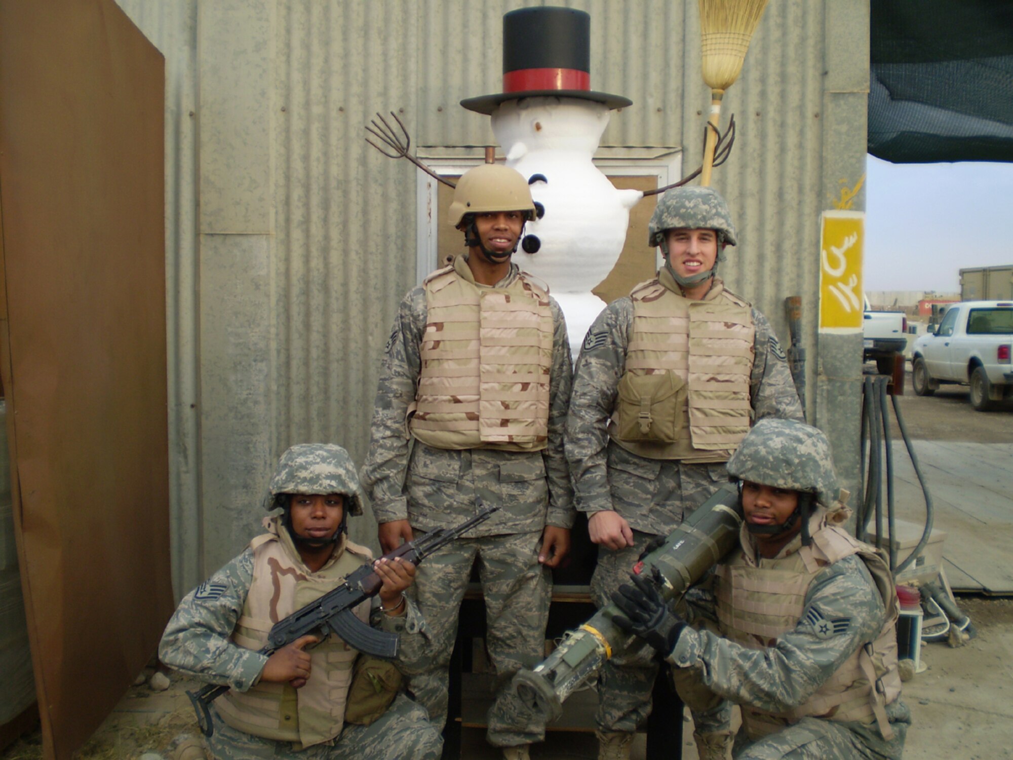 SEYMOUR JOHNSON AIR FORCE BASE, N.C. -- Not to be outdone by their fellow Reservist in Afghanistan, these deployed 916th Civil Engineers demonstrate that the holiday spirit is still alive and well in Iraq (or at least some snow is falling). Standing from left to right are: Staff Sgt. Terrica Jones, Senior Aiman Kevin Harris, Staff Sgt. Bryce Kendall and Senior Airman Mitchell Epps. These reservists work in heating, air conditioning and ventilation within the civil engineers squadron. 