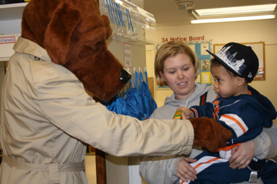 McGruff the Crime Dog makes friends with Kurtic Kerins and his mother Amanda at the Alconbury Child Development Center. Members of the 423rd Security Forces Squadron visited the CDC as part of a community policing event. 
