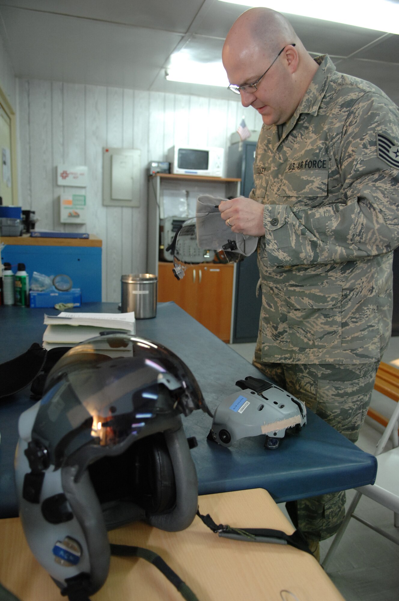BALAD AIR BASE, Iraq -- Tech. Sgt. Christopher Kelley, 23rd Expeditionary Fighter Squadron air crew flight equipment technician, re-assembles a joint helmet mounted cueing system after precisely cutting a helmet visor for an F-16 Fighting Falcon pilot here, Feb. 14. Sergeant Kelley is deployed from Spangdahlem Air Base, Germany. (U.S. Air Force photo/ Senior Airman Julianne Showalter)

