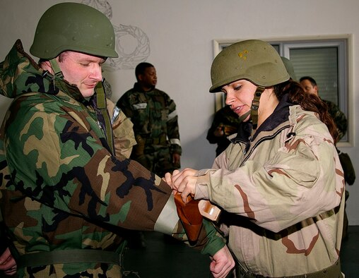 1st Lt. Danielle Berra, right, 352nd Operations Support Squadron, puts M-9 tape on Maj. Richard French, 352nd OSS, during Chemical, Biological, Radiological and Nuclear Defence Survival Skills training Feb. 5, 2008. Unit schedulers for each squadron register their personnel for practical training at the 100th Civil Engineer Squadron Readiness and Emergency Flight in Building 562. Classes are held Tuesdays and Thursdays. (U.S. Air Force photo by Karen Abeyasekere)
