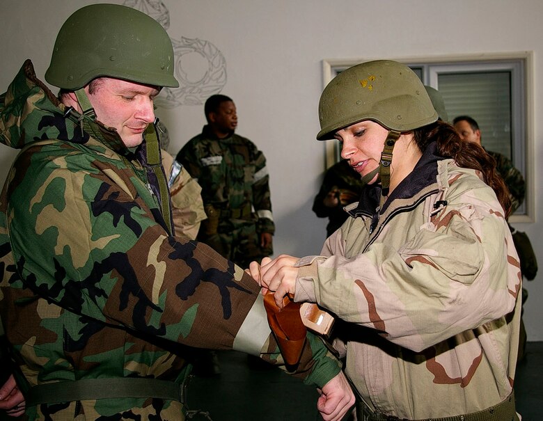 1st Lt. Danielle Berra, right, 352nd Operations Support Squadron, puts M-9 tape on Maj. Richard French, 352nd OSS, during Chemical, Biological, Radiological and Nuclear Defence Survival Skills training Feb. 5, 2008. Unit schedulers for each squadron register their personnel for practical training at the 100th Civil Engineer Squadron Readiness and Emergency Flight in Building 562. Classes are held Tuesdays and Thursdays. (U.S. Air Force photo by Karen Abeyasekere)