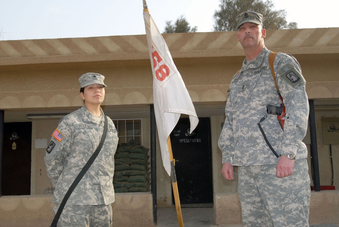 Army Spc. Juliana Rizzo, a supply specialist in Company E, 3rd Battalion, 158th Aviation Regiment, Task Force 12, Multinational Division Baghdad, stands with Army 1st Sgt. Foy Dix, of Company E, before her lateral promotion to corporal. Rizzo, a native of Long Island, N.Y., speaks Arabic and Spanish and knows several phrases in Hindu. Photo by Sgt. Brandon Little, USA