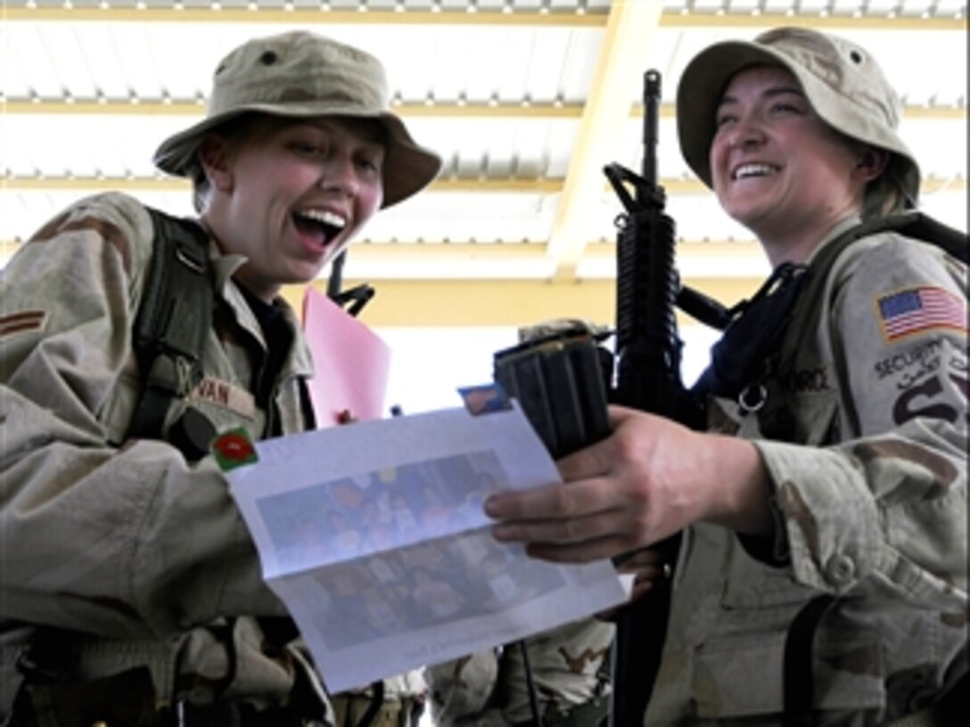 U.S. Air Force Airmen 1st Class Kathleen Sullivan and Lindsay Judkins are surprised to receive Valentine's Day cards from Texas elementary school students, Feb. 13, 2008, at a Southwest Asia air base. Both airmen are assigned to the 379th Expeditionary Security Forces.