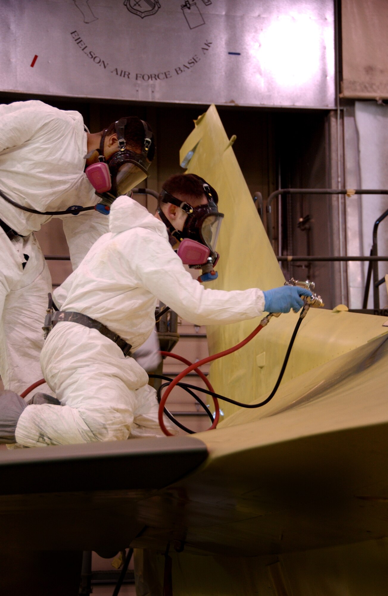 EIELSON AIR FORCE BASE, Alaska --Senior Airman Frank Reardon and Airman 1st Class Eric Rickards, 354th Maintenance Squadron sheet metal workers, apply a jungle theme to an F-16 Feb. 14, 2008, at the corrosion facility. With the swap of the F-16?s from Kunsan to Eielson in support of their new mission as Aggressors each aircraft is applied with a scheme being Arctic Flanker, Blue Flanker or Lizard Flanker, which will stand out from other aircraft that participate in Red Flag-Alaska. (U.S. Air Force photo by Airman 1st Class Christopher Griffin)