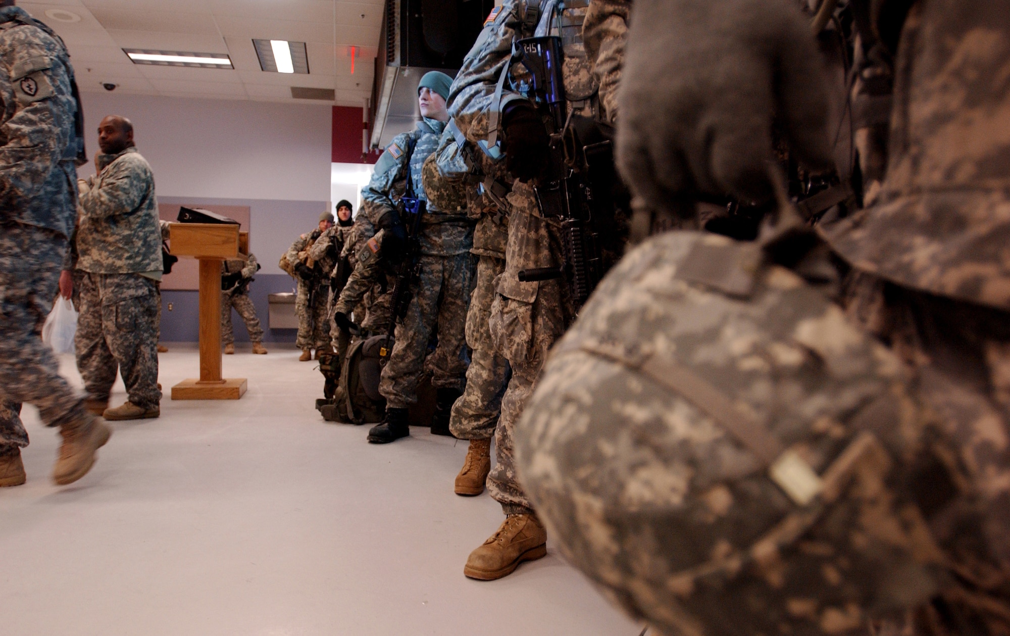 Members of the Army's First Stryker Brigade Combat Team of the 25th Infantry Division, 1st Battalion 24th Infantry Regiment, Charlie Company from Fort Wainwright, Alaska gets in line for roll call at the Joint Mobility Center located at Eielson AFB, Alaska before their departure for their deployment to the Republic of Korea in support of the Foal Eagle exercise.  It is the first time the USAF and US Army in Alaska has used joint assets to project combat power protection out of Alaska.

(U.S Air Force photo by: Staff Sgt Eric T. Sheler)
