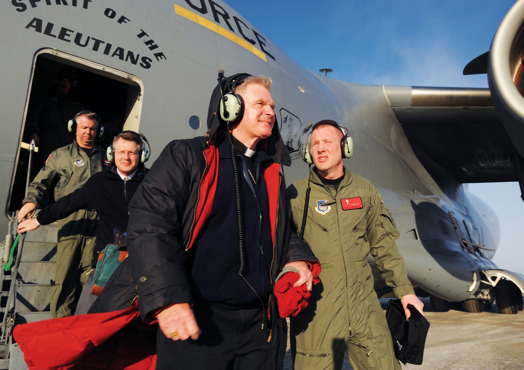 The Most Reverend Roger Schwietz, the Archbishop for the Archdiocese of Anchorage, and Chaplain (Capt.) Kyle Roehrig, 3rd Wing, exit the C-17 after a 90-minute orientation flight over Alaska. Archbishop Schwietz is an honorary commander and received the ride to learn more about the squadron?s mission. In addition to the flight, the archbishop also toured the C-17 simulator and visited with base chaplains.   (U.S. Air Force photo/Airman 1st Class Matt Owens)