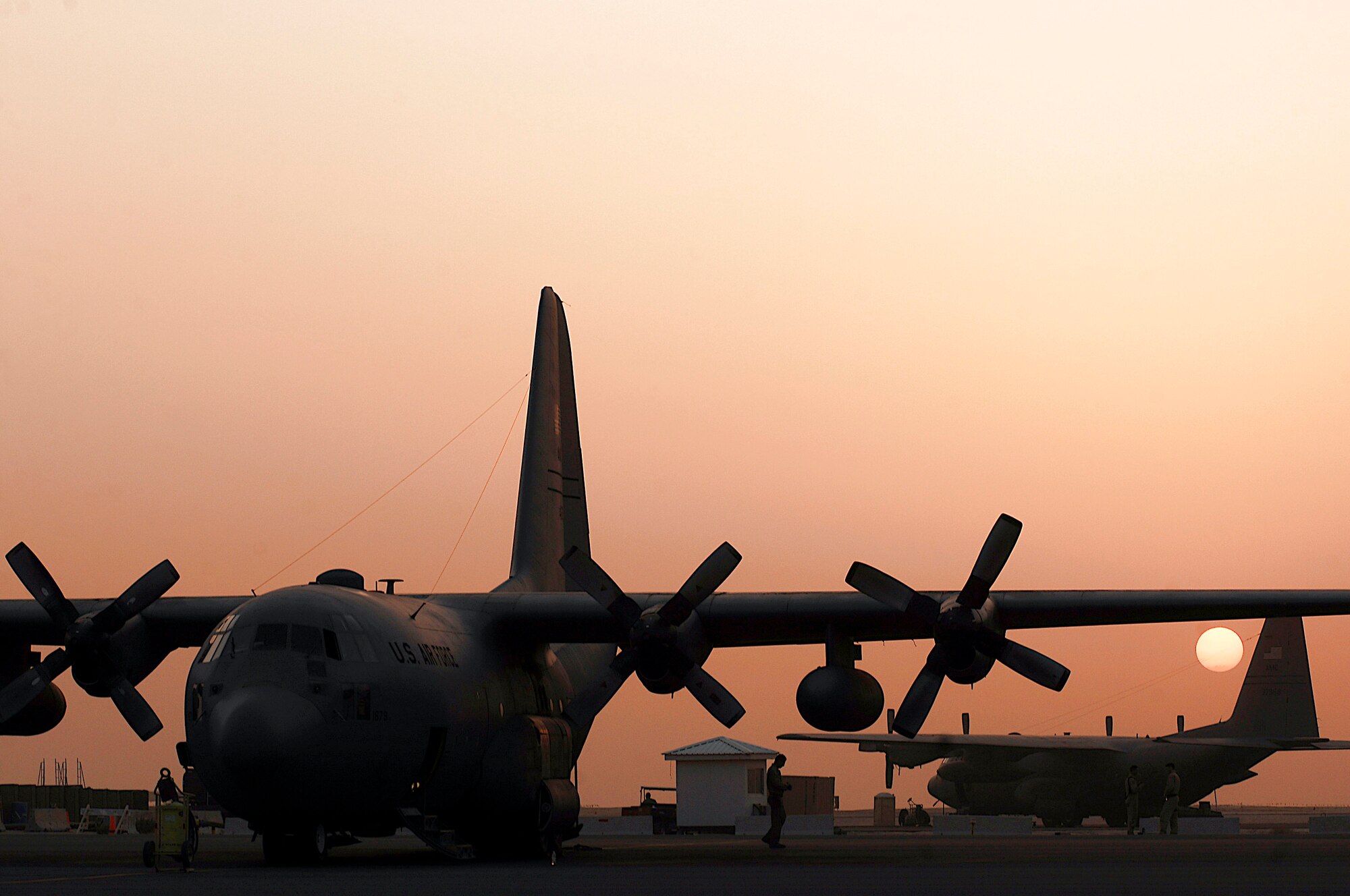 C-130 Hercules aircraft stand by for missions at an air base in Southwest Asia. These aircraft will help move coalition forces and equipment throughout Operations Enduring and Iraqi Freedom. (U.S. Air Force photo/Staff Sgt. Patrick Dixon)