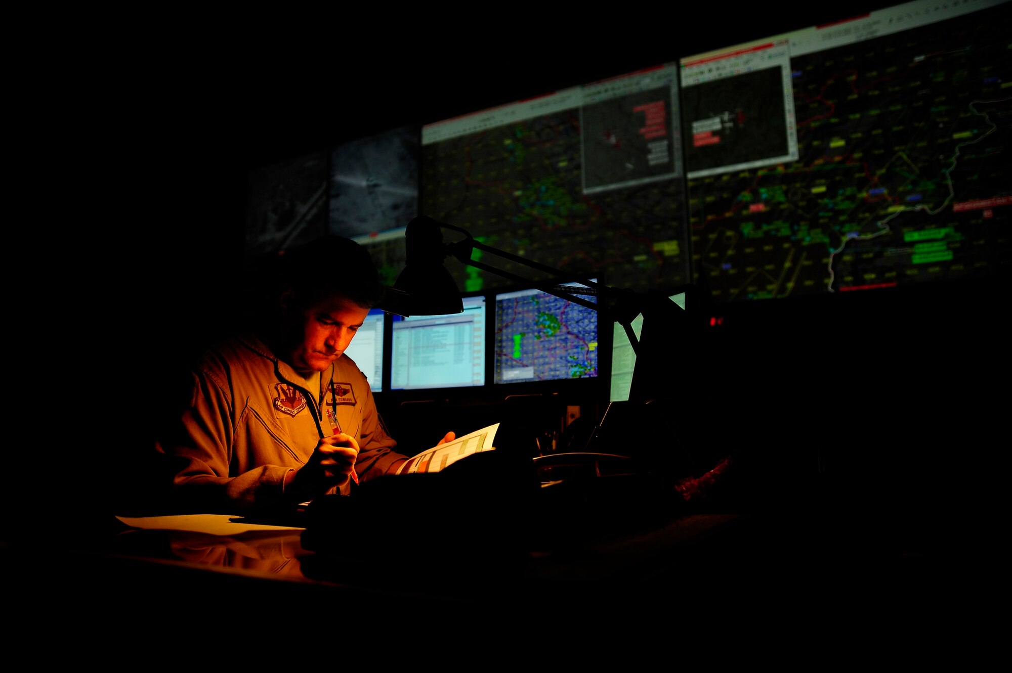 SOUTHWEST ASIA -- U.S. Air Force Lt. Col. Ken Edwards reviews and monitors the Combined Forces Air Component Commander's Air Tasking Order on the floor of the Combined Air and Space Operations Center in Southwest Asia on Feb. 15, 2008. Colonel Edwards is the Chief of Combat Operations Division and is deployed here from the 705th Training Squadron, Hurlburt Field, Fla. (U.S. Air Force photo by Master Sgt. Andy Dunaway)