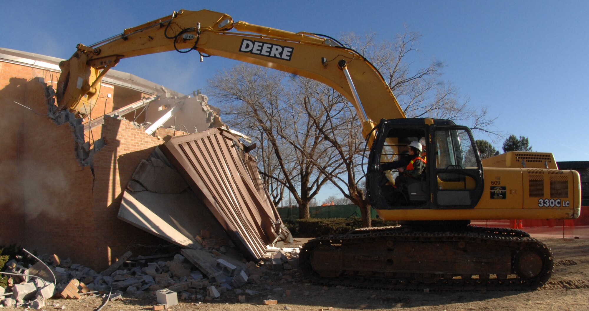 CANNON AIR FORCE BASE, N.M. - Col. Babette Lenfant, 27th Special Operations Mission Support Group commander, uses an exavator to remove a piece of Bldg. 1247 Feb. 13. The building is being demolished to make way for the new Airmen's Center/dining facility. (U.S. Air Force photo by Airman 1st Class Evelyn Chavez)