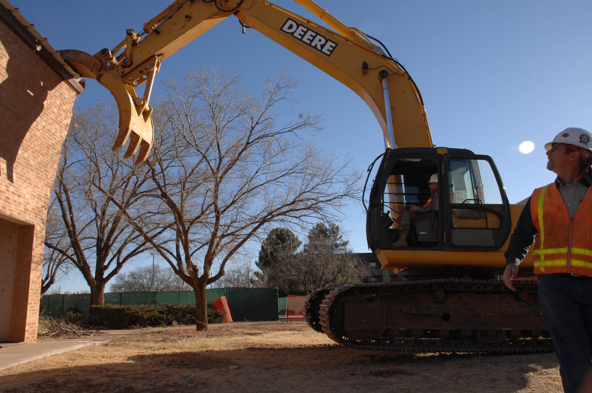 CANNON AIR FORCE BASE, N.M. - Col. Timothy Leahy, 27th Special Operations Wing commander, uses an excavator to bring down the first piece of Bldg. 1247 Feb. 13. The building is being demolished to make way for a new Airmen's Center/dining facility. (U.S. Air Force photo by Airman 1st Class Evelyn Chavez)