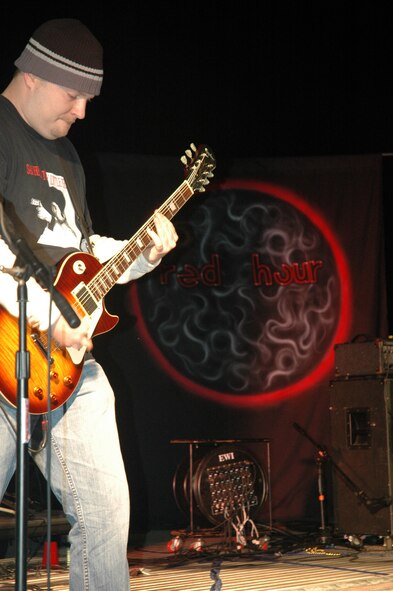 Chris Dahmer, member of the local band Red Hour and the 325th Fighter Wing Public Affairs office, plays his guitar during Rockfest 2008 Saturday.  Red Hour was just one of ten local bands to come out to Tyndall Air Force Base to perform.  (photo by Airman 1st Class Anthony J. Hyatt)