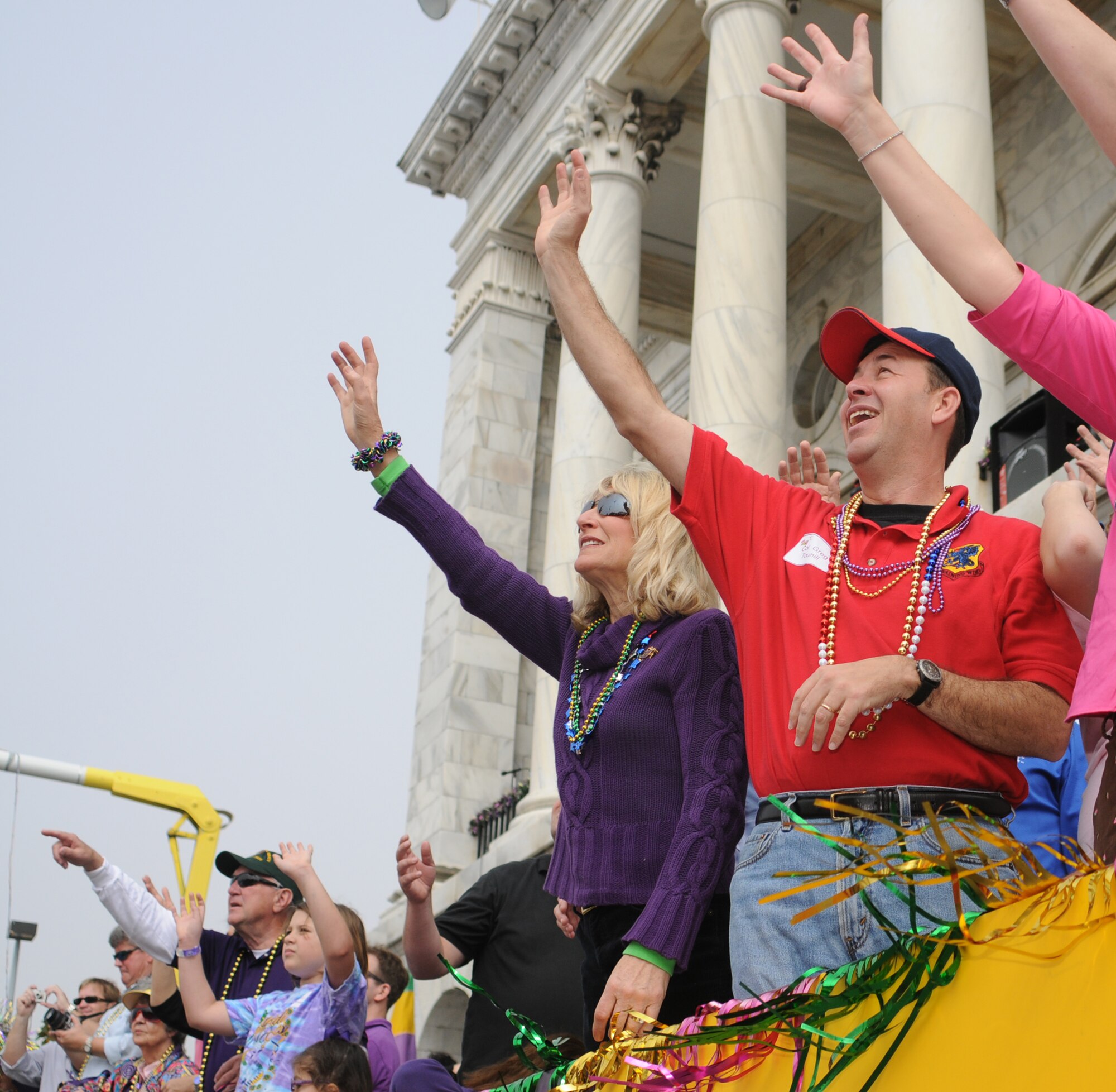 Left, Paula Gould and Col. Greg Touhill wave their hands in the air in hopes of catching beads in front of Biloxi City Hall during the Gulf Coast Carnival Association Mardi Gras parade Feb. 5.  Colonel Touhill is the 81st Training Wing commander.  Mrs. Gould's husband is Maj. Gen. Mike Gould, 2nd Air Force commander.
(U.S. Air Force photo by Kemberly Groue)