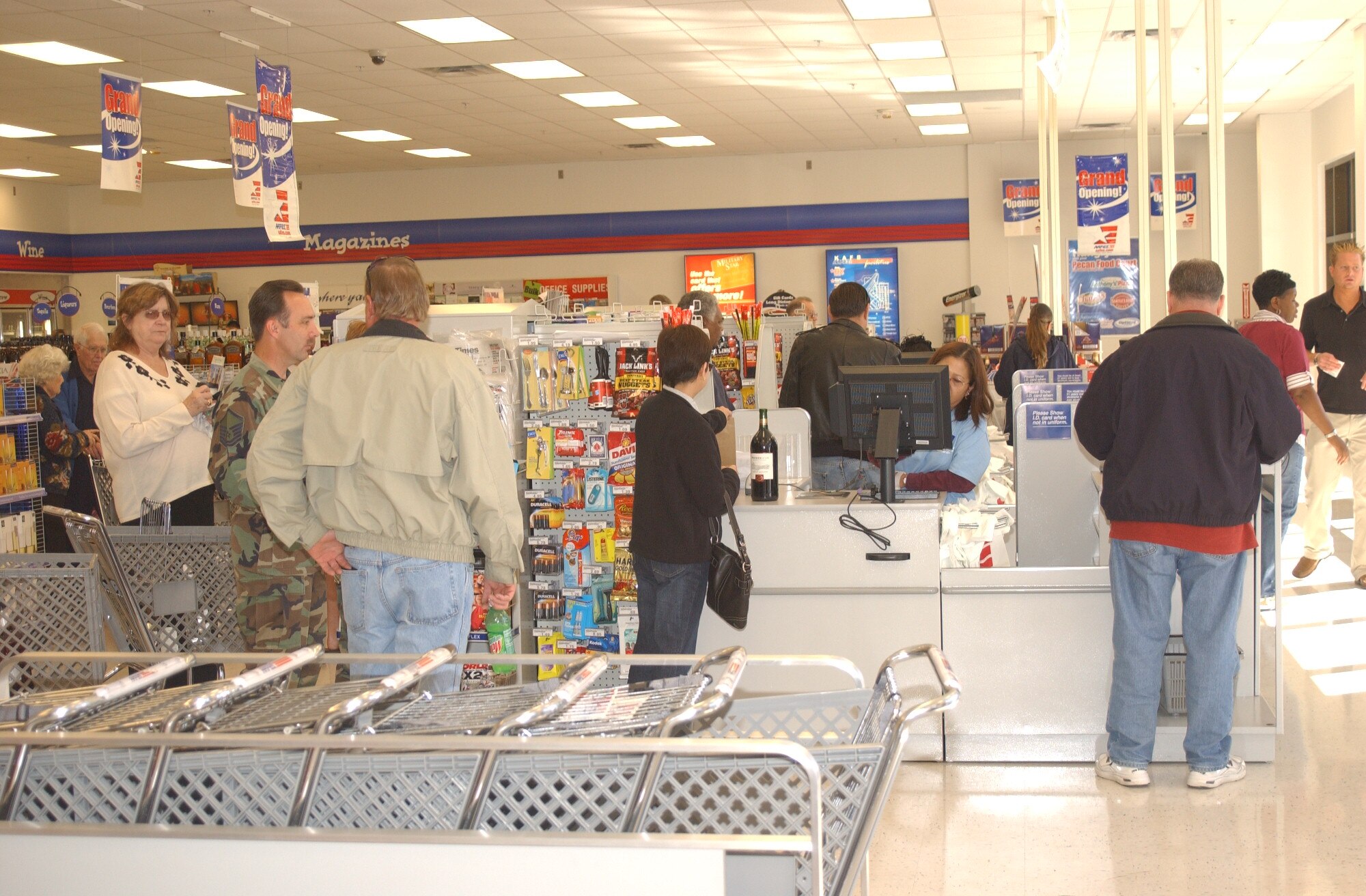 Opening day shoppers stand on line ath the shoppette to check out Saturday, at the grand opening of the AAFES complex.  Among the new shoppette, the complex has an automobile care center, a 20-pump gas station, class VI store, Enterprise Car Rental and a four-chair barber shop.  (U.S. Air Force photo by Airman 1st Class David Salanitri)