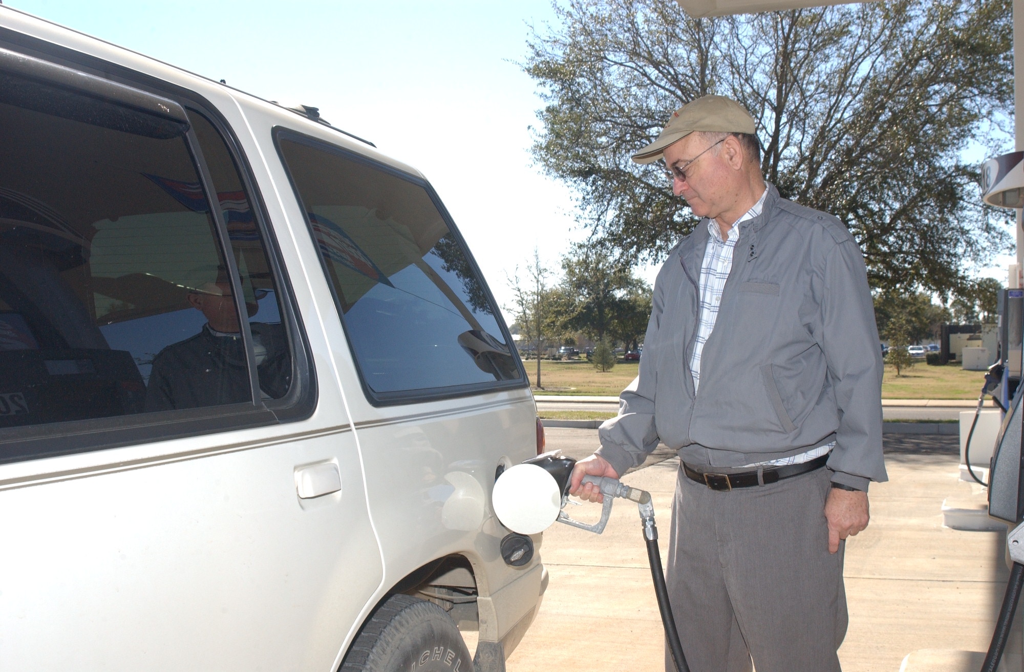 Gary Sawyer from Orlando fills up his car Friday morning at the grand opening of the Army and Air Force Exchange Service complex here.  The complex is located on the corner of Meadows Drive and Larcher Boulevard.  (U.S. Air Force photo by Airman 1st Class David Salanitri)