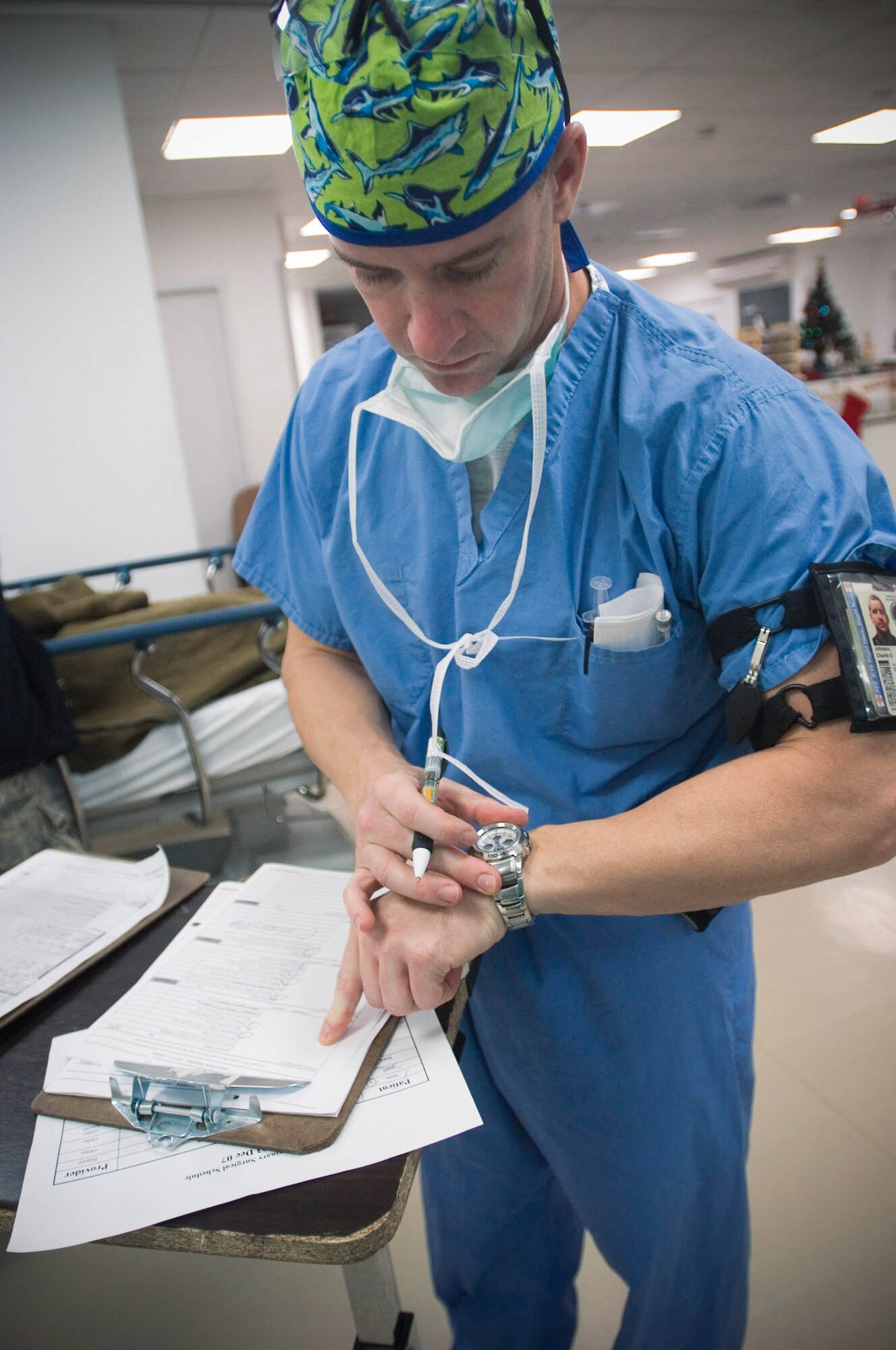 Capt. Charlie Johnson checks the time as he releases a patient to the post-anesthesia care unit Dec. 4 at the Air Force Theater Hospital at Balad Air Base, Iraq. Captain Johnson is a certified registered nurse anesthetist deployed from Travis Air Force Base, Calif. (U.S. Air Force photo/Tech. Sgt. D. Clare) 