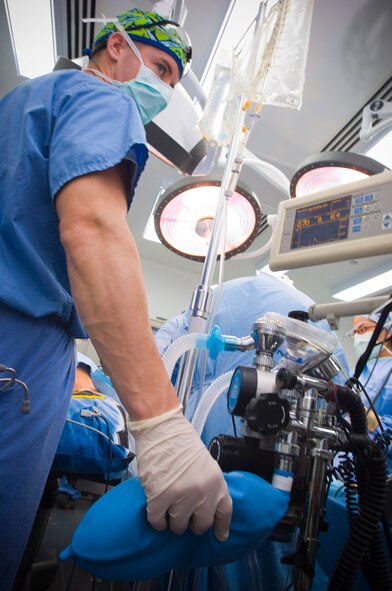 Capt. Charlie Johnson assists with ventilation to ensure the patient's lungs are filled with oxygen at the end of a surgical procedure Dec. 4 at the Air Force Theater Hospital at Balad Air Base, Iraq. As the patient's lungs fill with oxygen, he will be gradually revived from anesthesia. Captain Johnson is a certified registered nurse anesthetist deployed from Travis Air Force Base, Calif. (U.S. Air Force photo/Tech. Sgt. D. Clare) 