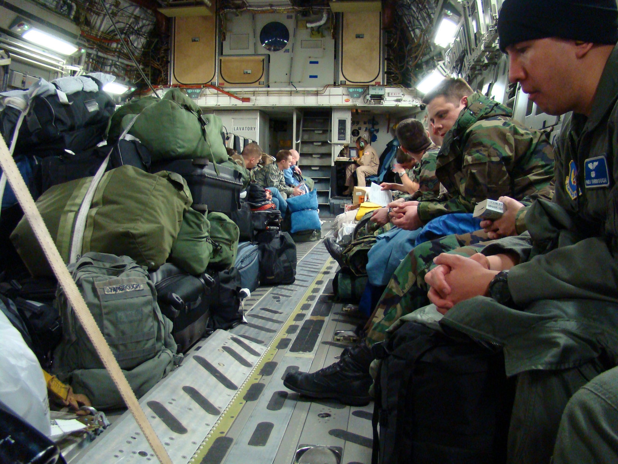 Airmen settle in on board a C-17 Globemaster Feb. 12 to support President George Bush's visit to Ghana scheduled for the upcoming weeks. The six-hour flight out of Charleston Air Force Base, S.C., took the Airmen to join other Soldiers, Sailors and Marines who have deployed to provide forward operating support for the president's visit in Africa. (U.S. Air Force photo/Tech. Sgt. Denise Johnson) 
