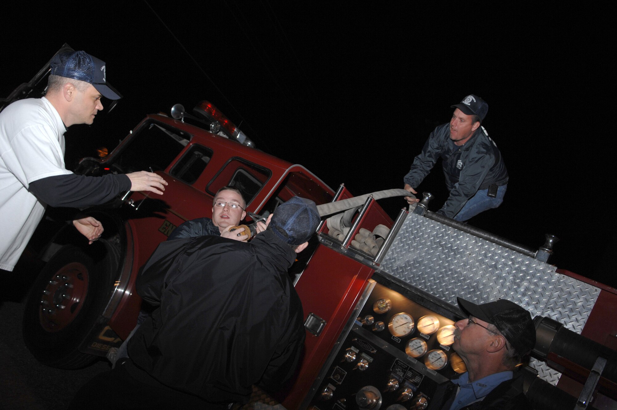 Volunteer firefighters of the Westside Fire and Rescue Department re-lay
water hoses in their truck as part of bi-monthly training and equipment
up-keep.  This method of packing the fire hose prevents it from becoming
tangled and makes it easily accessible when needed. (U.S Air Force photo by
Senior Airman Angelita Lawrence)
