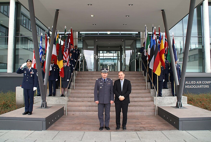 Senior Master Sgt. Mark Marson, NATO provost marshal police superintendent, salutes while NATO military police make up the formation during an official ceremony. (Courtesy Photo)  