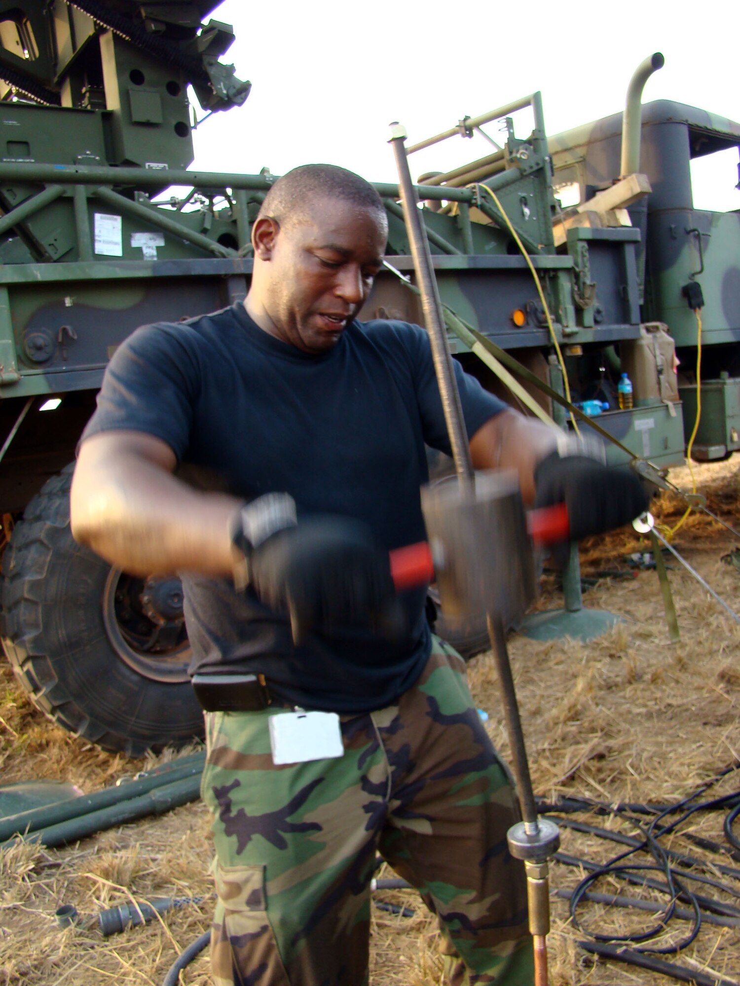 ACCRA, Ghana – Tech. Sgt. Andrew Binns, a ground radar systems craftsman from the 603rd Air Control Squadron at Aviano Air Base, Italy, drives a ground rod for a radar shelter into the ground as he and his teammates set up communications equipment in Accra, Ghana, Feb. 14. The Airmen are part of a multi-service team providing communications capabilities in support of U.S. President George Bush’s visit to the West African nation. (U.S. Air Force Photo by Tech. Sgt. Denise Johnson)