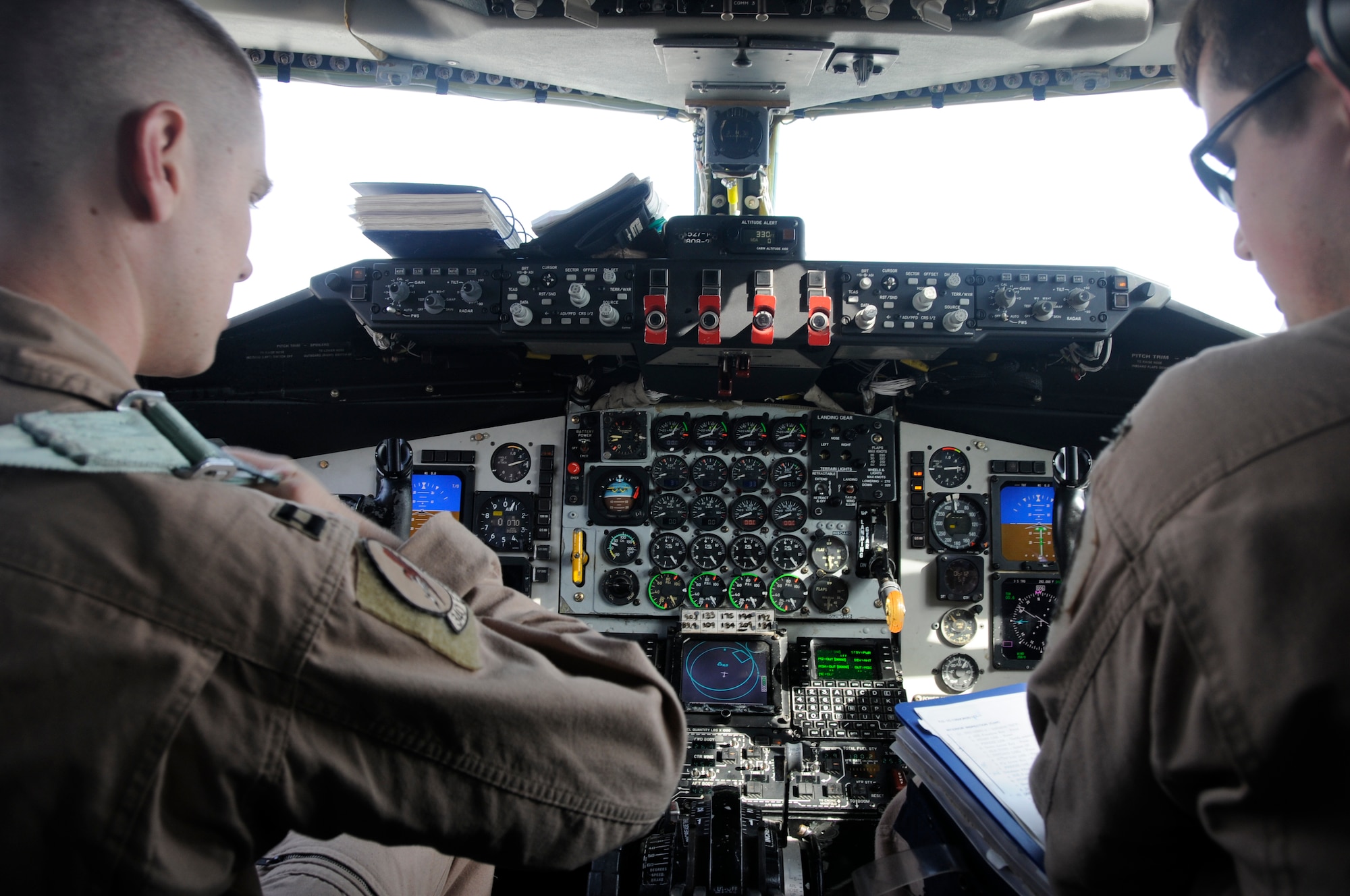 (left to right) Pilot, Capt. Jon Holland and Co-pilot, First Lt. Dan Pollock conduct pre-flight checks from the cockpit of a KC-135 Stratotanker Feb. 14. Both are deployed from Grand Forks Air Force Base and belong to the 340th Expeditionary Air Fueling Squadron. (U.S. Air Force Photo/Senior Airman Domonique Simmons)
