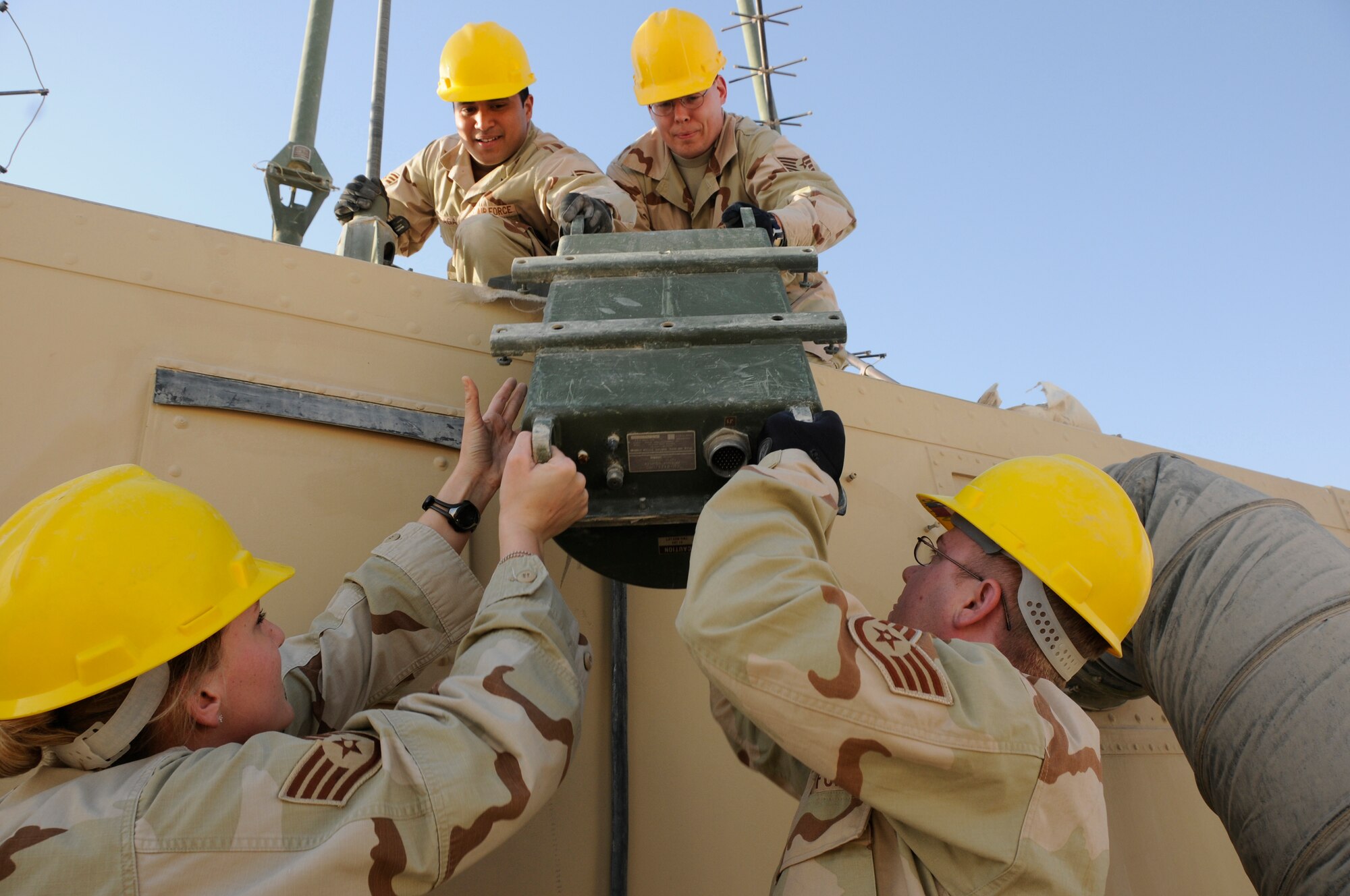 Airmen assigned to the 71st Expeditionary Air Combat Squadron, team to make repairs on a communications structure inside their compound Feb. 10. (U.S. Air Force photo/Senior Airman Domonique Simmons)