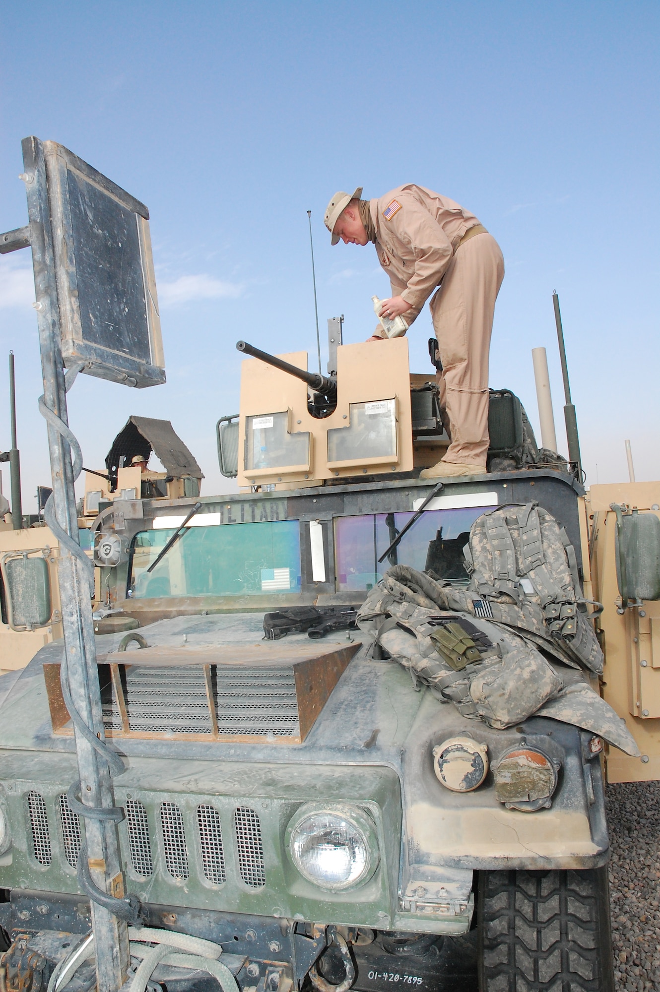 CAMP BUCCA, Iraq -- Airman 1st Class Michael Tulip prepares an M-2 50 Caliber machine gun for an outside the wire mission Feb. 11, 2008. Airman Tulip is deployed with the 887th Expeditionary Security Forces Squadron, which conducts combat patrols to deter local insurgents from attacking Camp Bucca. The combat patrols include looking for improvised explosive devices and gathering intelligence by directly engaging Iraqis in the local communities. The squadron is the only U.S. defense force that provides continual patrols outside the wire in southeast Iraq. (U.S. Air Force Photo/Capt. Jason McCree)
