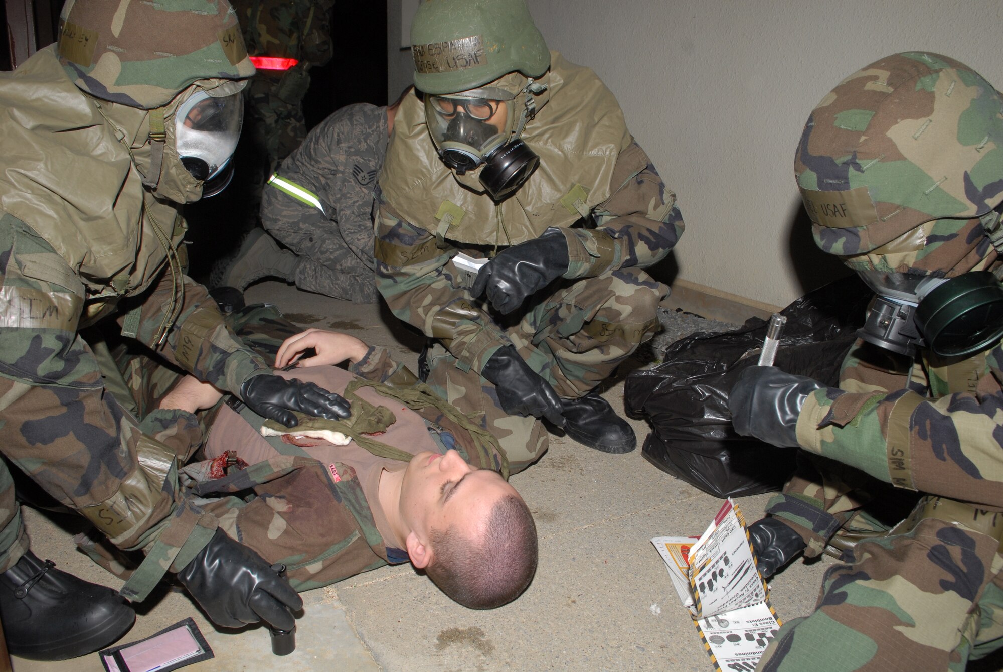 Airmen from the 961st Airborne Air Control Squadron, perform Self-aid and Buddy Care on Airman Christopher Leonard, 18th Medical Operations Squadron, for his lacerations to his arm and chest, after an attack scenario during local operational readiness exercise Beverly High 08-4 at Kadena Air Base, Japan, Feb. 14, 2008. The 18th Wing conducted the exercise from Feb. 10 to 15 to test Airmen's ability to respond in contingency situations. (U.S. Air Force photo/Staff Sgt. Chrissy FitzGerald)