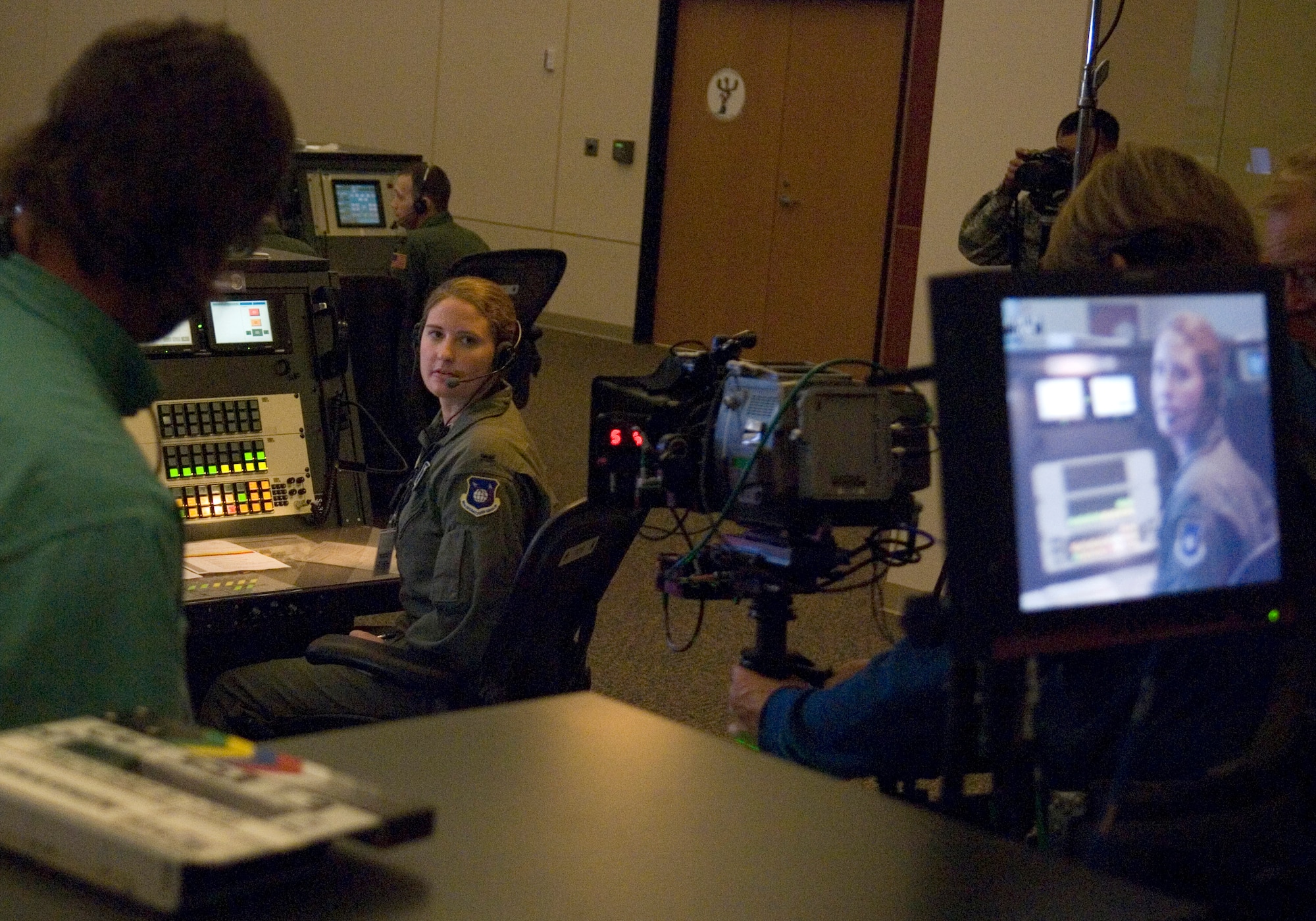 VANDENBERG AIR FORCE BASE, Calif.--First Lieutenant Lauren Neely, a launch control officer with the 2nd Range Operations Squadron, receives direction from the production crew during the filming of a commercial at the Western Range Operations Control Center here.  The commercial was one of three commercials being produced to both aid in recruiting as well as raise public awareness of three Air Force-unique capabilities.  These capabilities include the missions of Air Force Space Command and Air Force Cyber Command, as well as the Air Force's global reach. (U.S. Air Force photo/Tech. Sgt. Russell McBride)